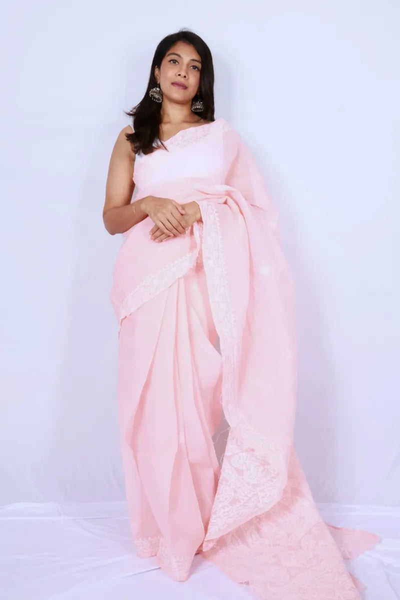 Baby pink cotton Chikankari saree from Lucknow with intricate white embroidered border and pallu Noolagam
