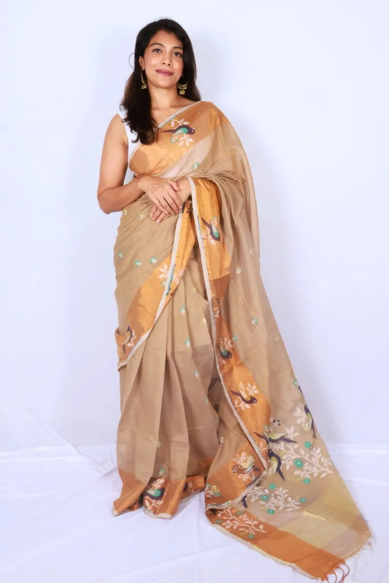 Beige and rust Phulia handloom slub cotton saree with floral motifs and rust toned border and pallu Noolagam
