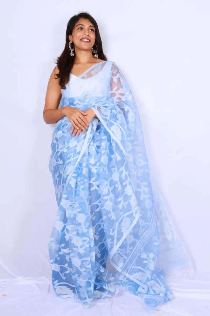 Sky blue Phulia muslin art silk Jamdani saree with delicate white floral motifs handwoven in West Bengal Noolagam