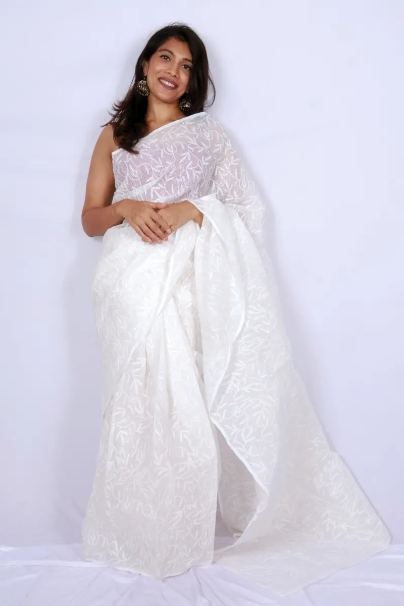 White Kota Chikankari saree from Lucknow with white-on-white hand embroidered floral and leaf motifs Noolagam